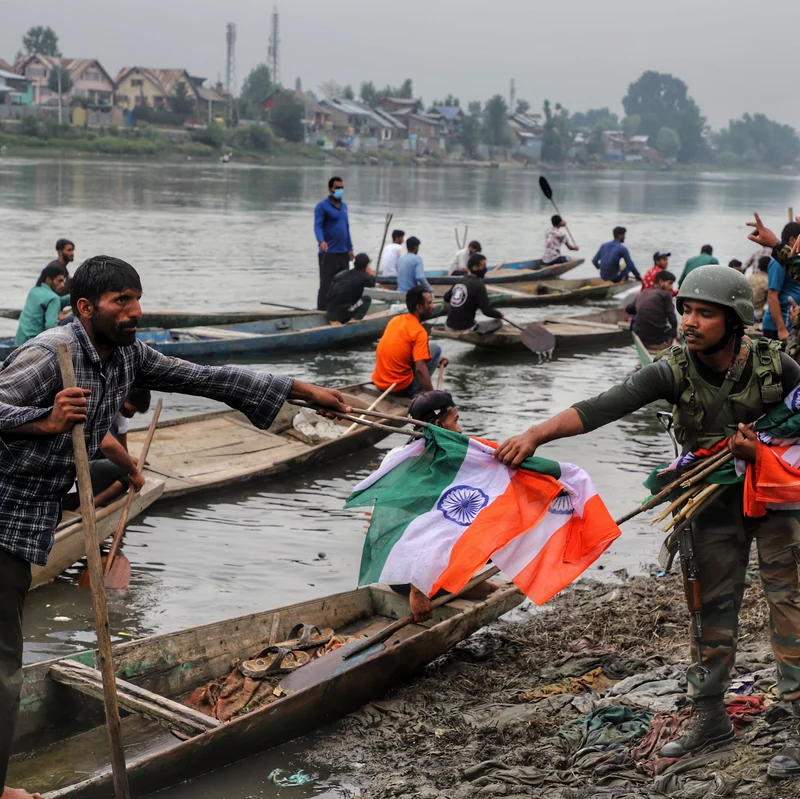 An Indian army soldier collects Indian national flags after a rally marking Indian independence in Sopore district, Baramulla, in Jammu and Kashmir, on Aug. 11.